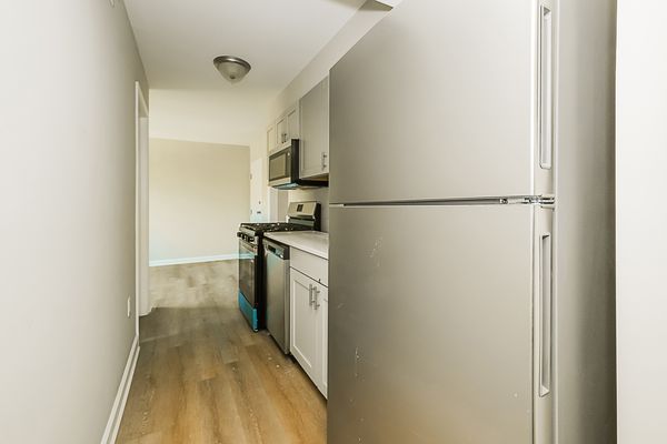 Kitchen second angle showing cabinet layout and storage