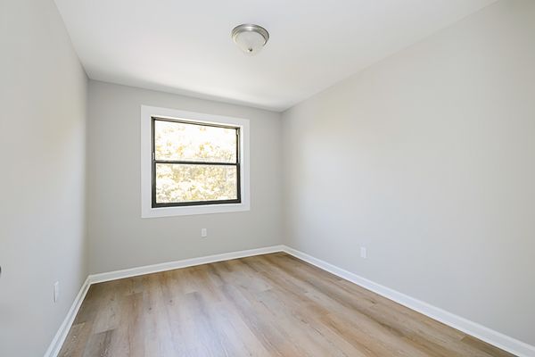 Living room shown vacant — hardwood floors and natural light