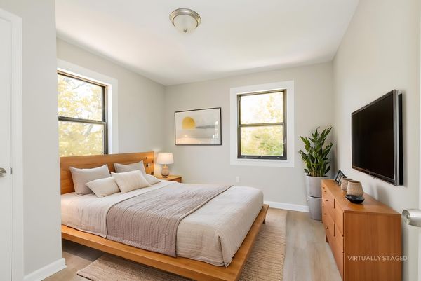 Primary bedroom virtually staged with queen bed and nightstands